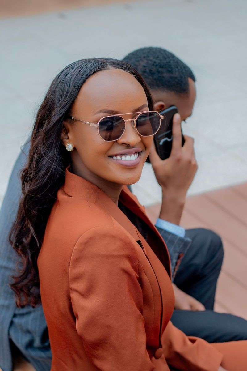 Smiling professionals sitting outdoors, epitomizing casual urban lifestyle and business communication.