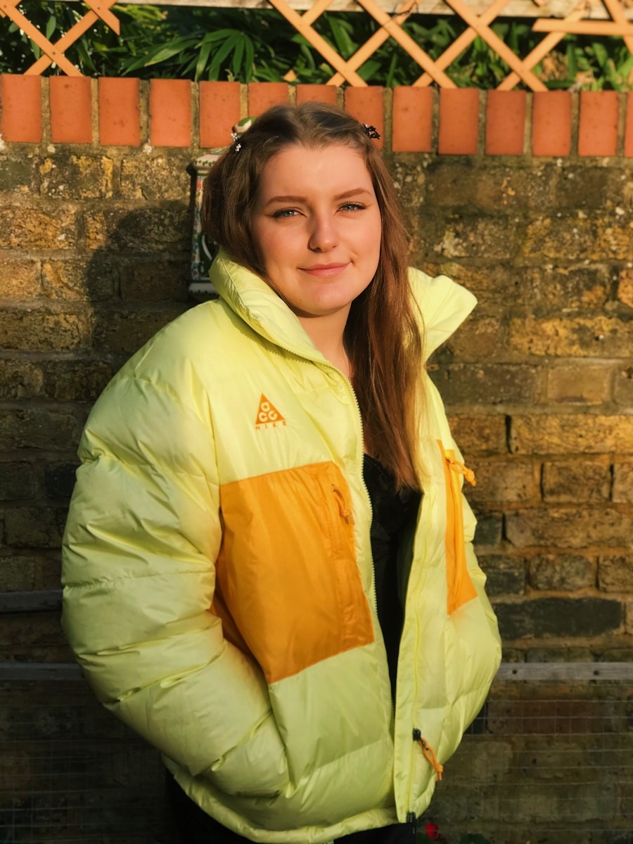woman in green and yellow jacket smiling